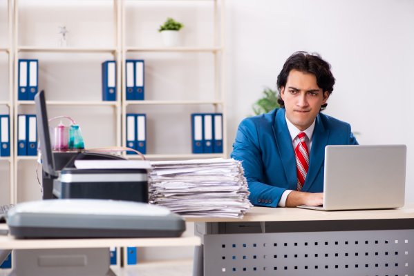 internet fax service best ringcentral online fax service man in blue suit in the office on desk folders and laptop on his desk and in the background